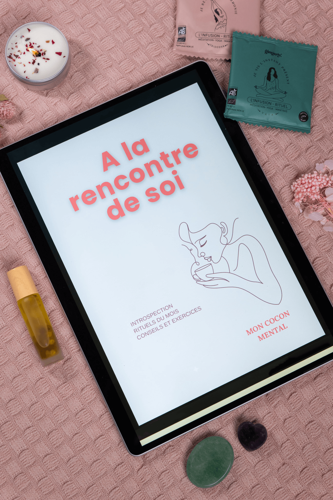 Carte cadeau présentée dans une box de bien-être avec un ruban, des produits de soin et une lettre d'accueil.s bien-être et des pierres pour le cocooning mental.